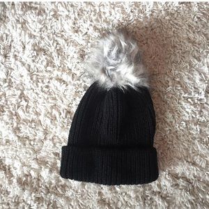Black winter hat with puff ball on top